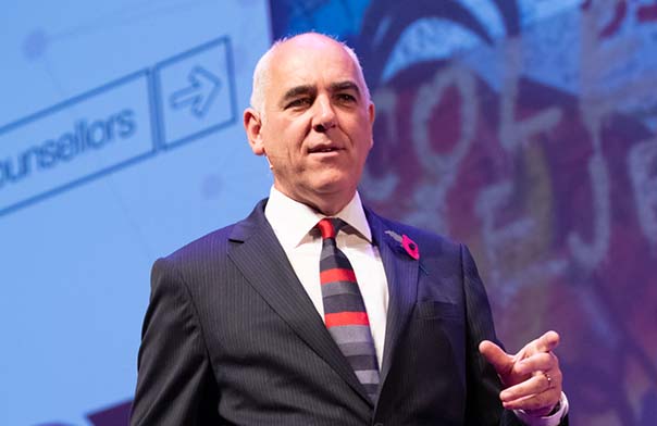Paul Redmond speaking on stage.