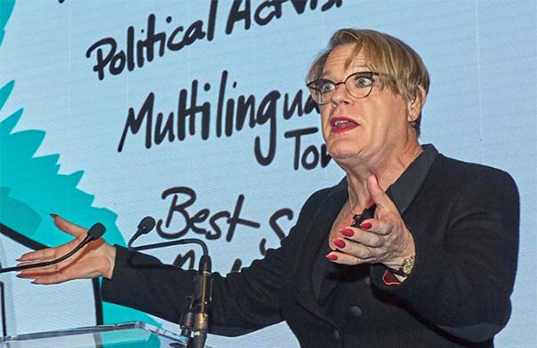 Eddie Izzard speaking on stage at an event