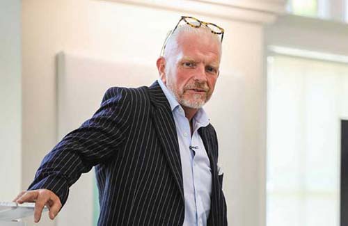Ellis Watson speaking on stage