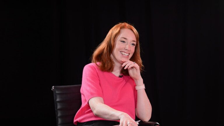 Hannah Fry speaking on a stage.