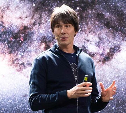 Brian Cox speaking on a stage.