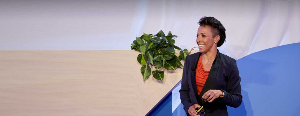 Kelly Holmes speaking on a stage.