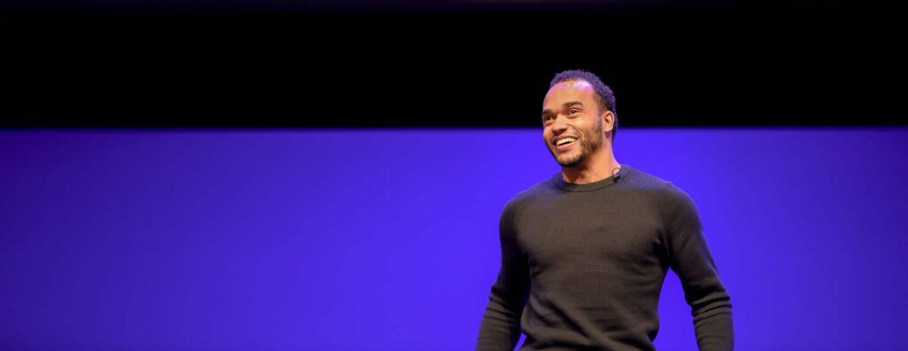 Nicolas Hamilton speaking on a stage.