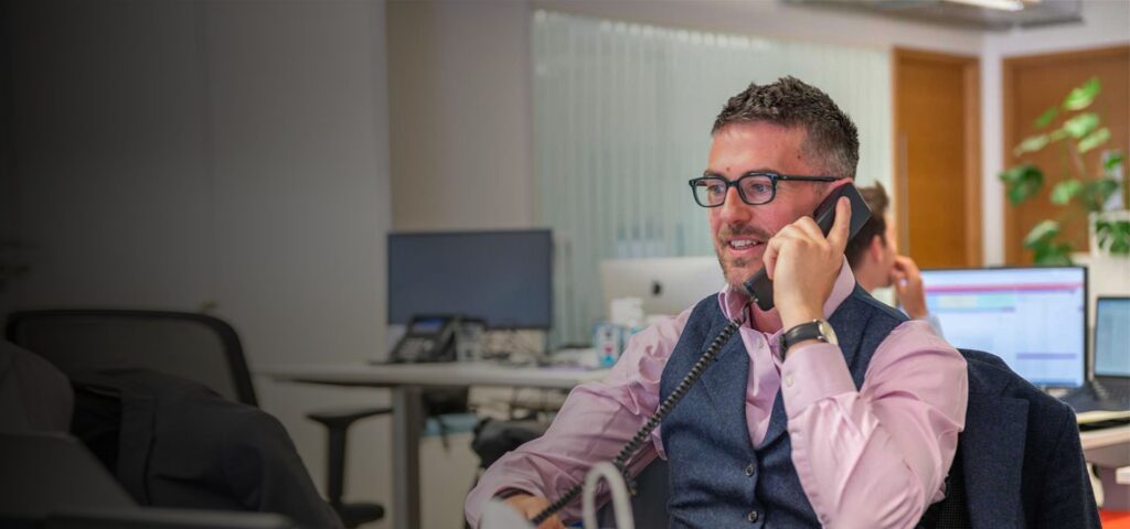 JLA agent speaking on the phone.